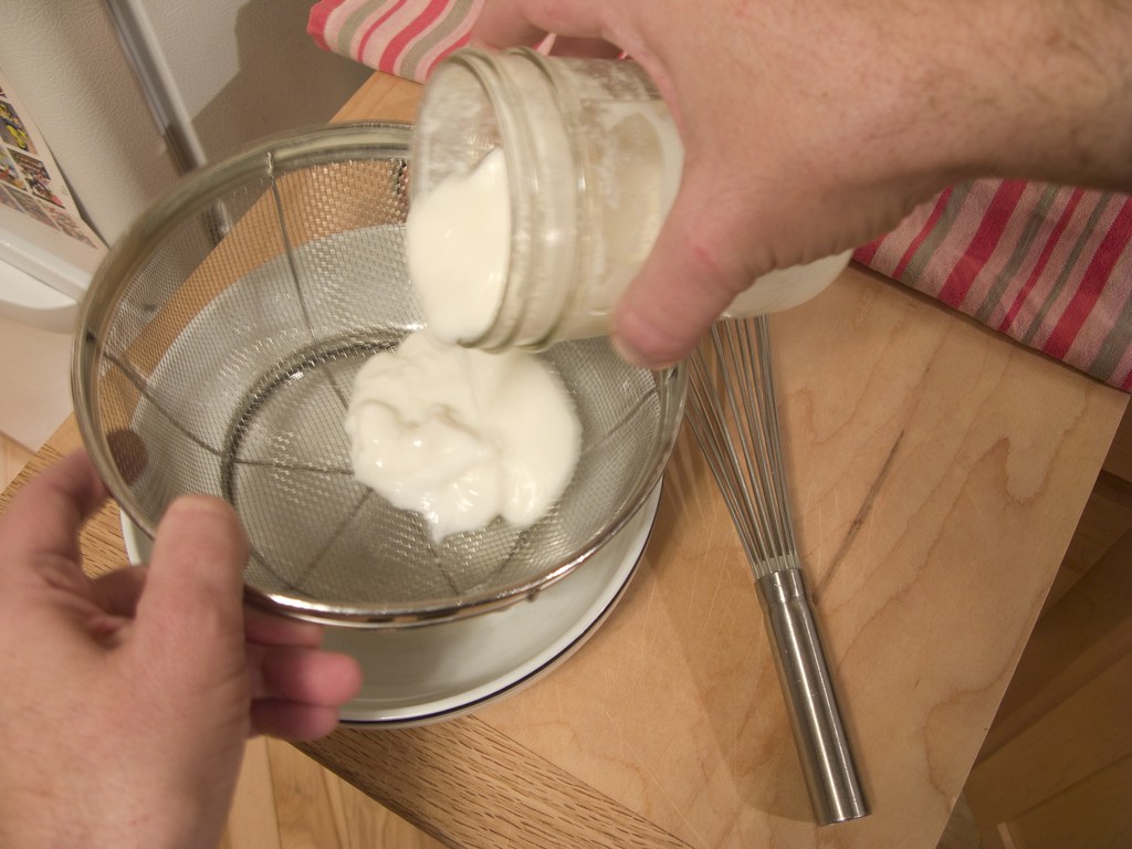 Straining fresh kefir for the next batch